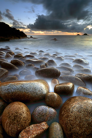 landscape photo of coastal rocks during golden hour HD wallpaper