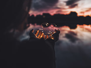person holding a string light