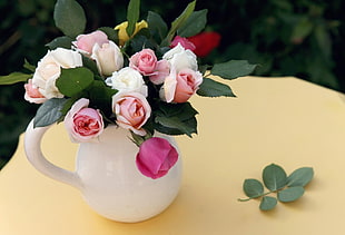 pink and white roses flower arrangement in white vase