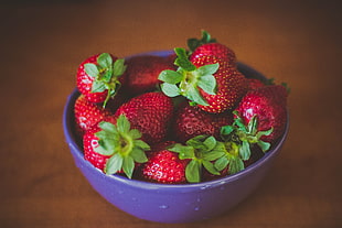 strawberries on purple bowl