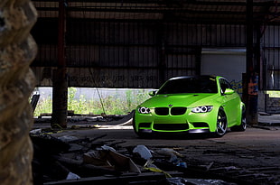 green BMW car park in garage during daytime