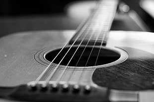 flat-top acoustic guitar in grayscale photography