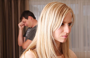 woman in blonde hair beside a man in gray shirt