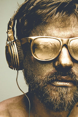 bearded man wearing black plastic framed sunglasses with headset