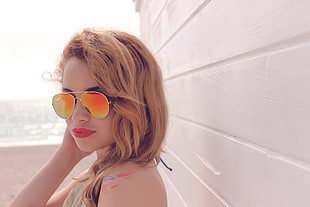 woman wearing orange tint sunglasses