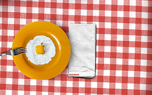 yellow plate with fork on plaid textile