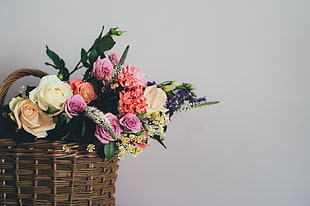 floral bouquet on brown wicker basket