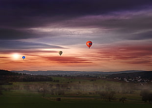 three hot air balloons on mid-air during sun set HD wallpaper