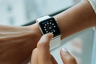 woman in white sports band apple watch