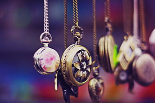 shallow photography of assorted pocket watches