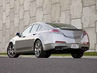 silver sedan near beige wall