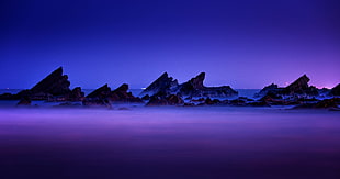 landscape photo of sea shore during night time