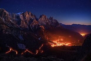 mountain with flowing lava, fire, stars, sky, night