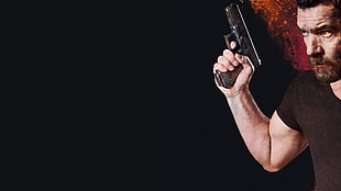 man holding black pistol HD wallpaper