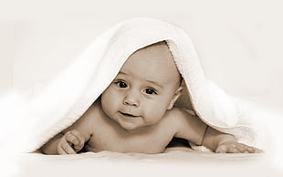 baby with white comforter