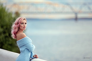 woman in blue top near body of water HD wallpaper