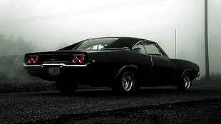 classic black Dodge Challenger coupe on asphalt road