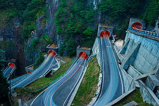 time-lapse photography of concrete road with tunnels surrounded with trees