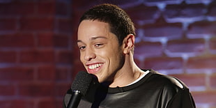man wearing black shirt smiling