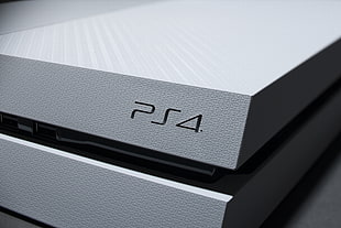 close photography of gray Sony PS4 console