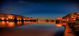 reflection of lighted city buildings on body of water during nighttime, garonne