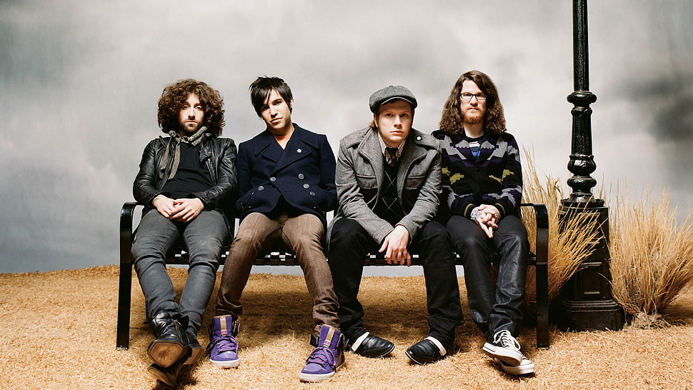 four men sitting on black metal bench HD wallpaper