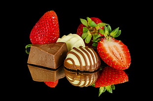 three assorted chocolates with slice strawberries HD wallpaper