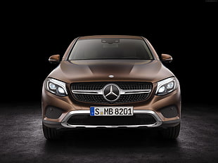 gold metallic Mercedes-Benz car on brown surface
