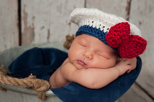 baby wearing blue and white knit hat HD wallpaper