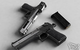 two pistols near black magazine