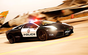 timelapse photography of black and white Lamborghini Gallardo police car along highway