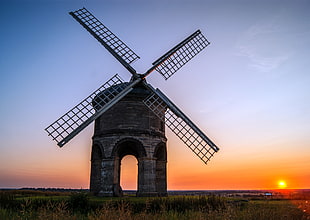 Windmill in the middle of farm during sunsetg HD wallpaper