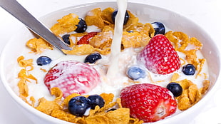 food photography of bowl of cereals with fruits and milk