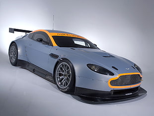 blue Aston Martin coupe on gray surface
