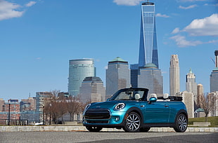 blue Mini Cooper convertible parked on road during daytime