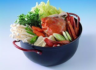 crab and vegetable dish on black cook pot