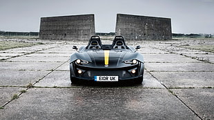 black and yellow KTM Xbow parked on gray concrete surface during daytime