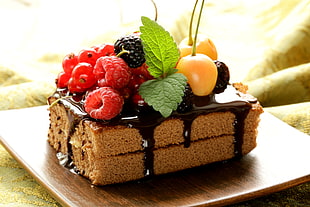 brown chocolate cake with assorted fruits on top