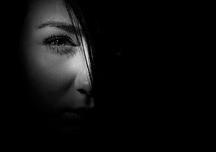 grayscale photography of woman's half face