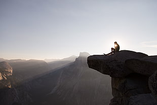 man on cliff during daytime HD wallpaper