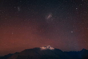 aerial view of mountain under black sky with stars, queenstown, otago
