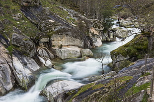 waterfalls between rock boulders HD wallpaper