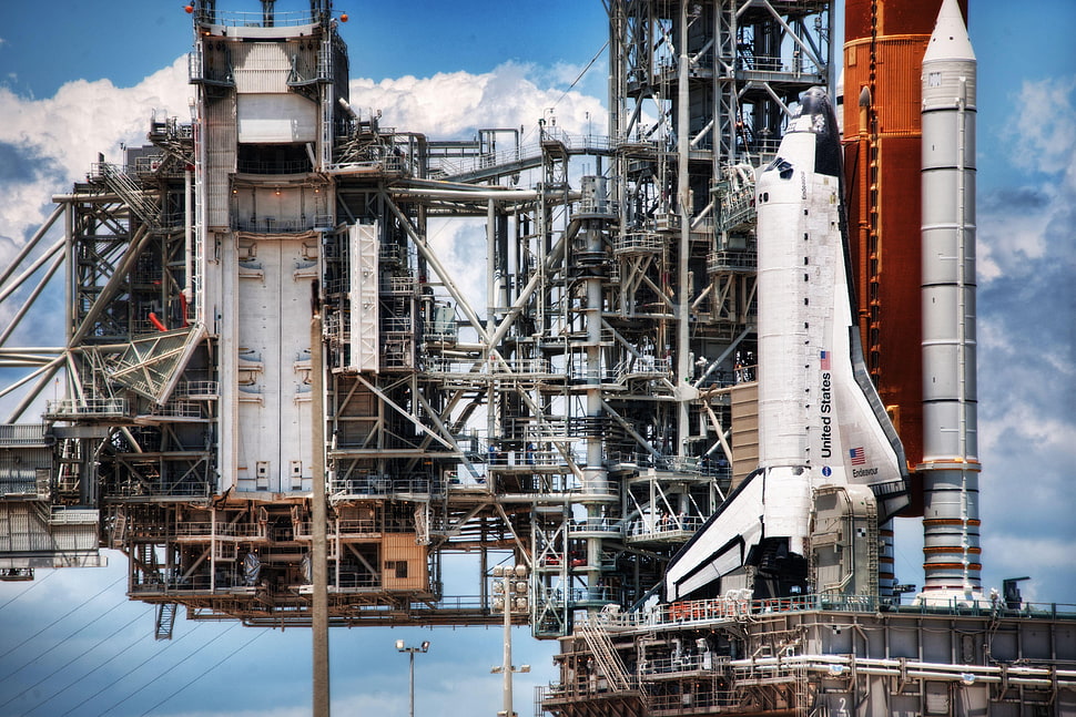 architectural photography of NASA rocket ship launch pad with space shuttle under clear sky during daytime HD wallpaper