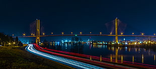 timelapse photography of vehicles traveling near suspension bridge during nighttime HD wallpaper