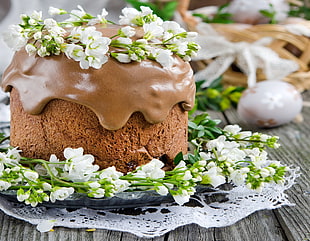 baked cake with white petaled flower on top