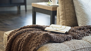 book on brown fur comforter