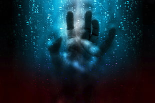 human hands between raindrops