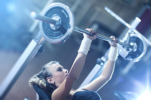 woman carrying barbell