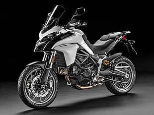 white and black Ducati touring sports motorcycle with black background