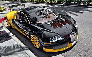 black and yellow Bugatti Veyron parked on the side of the road during daytime